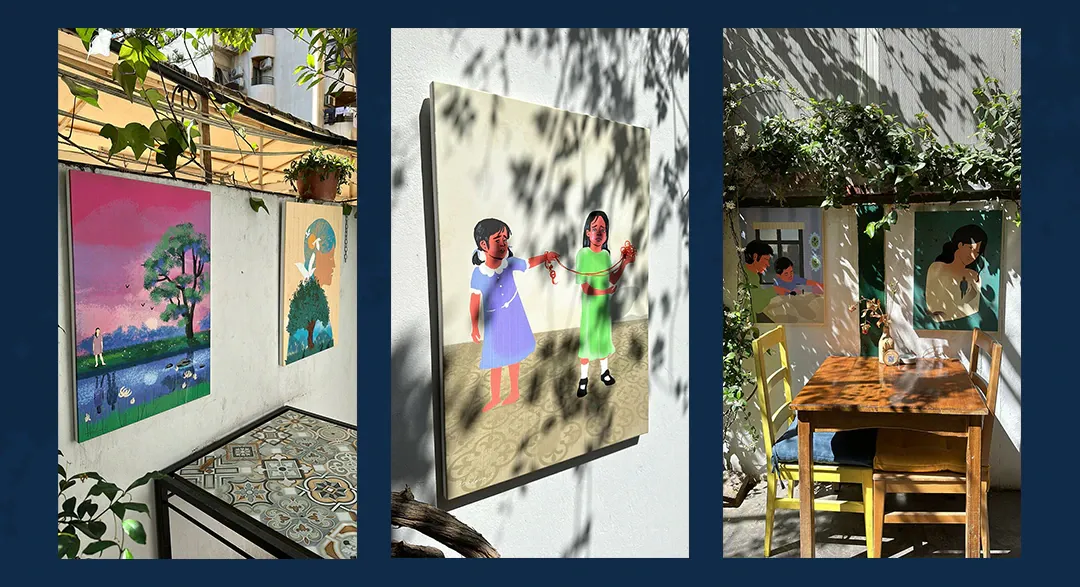 Book illustrations exhibited on the walls of a sunlit courtyard